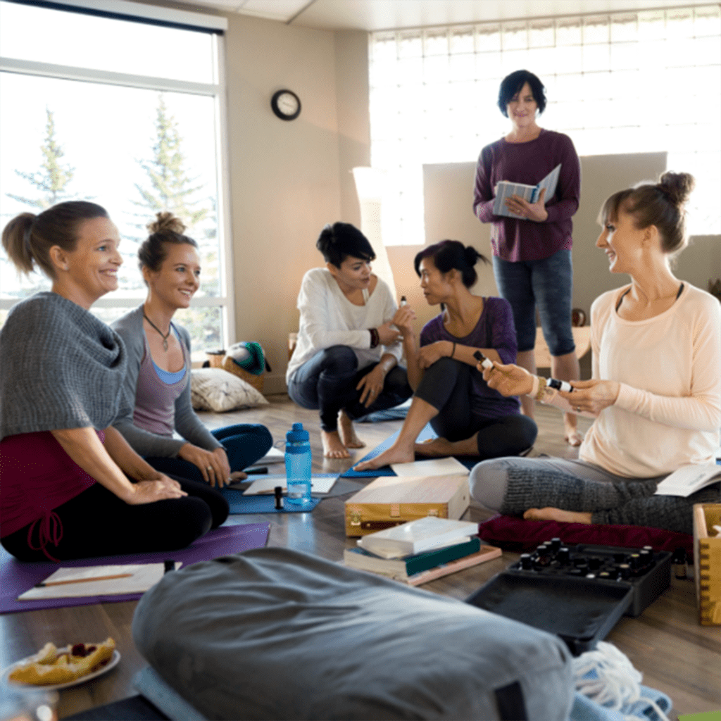 community of women at yoga retreat having a wellness meeting